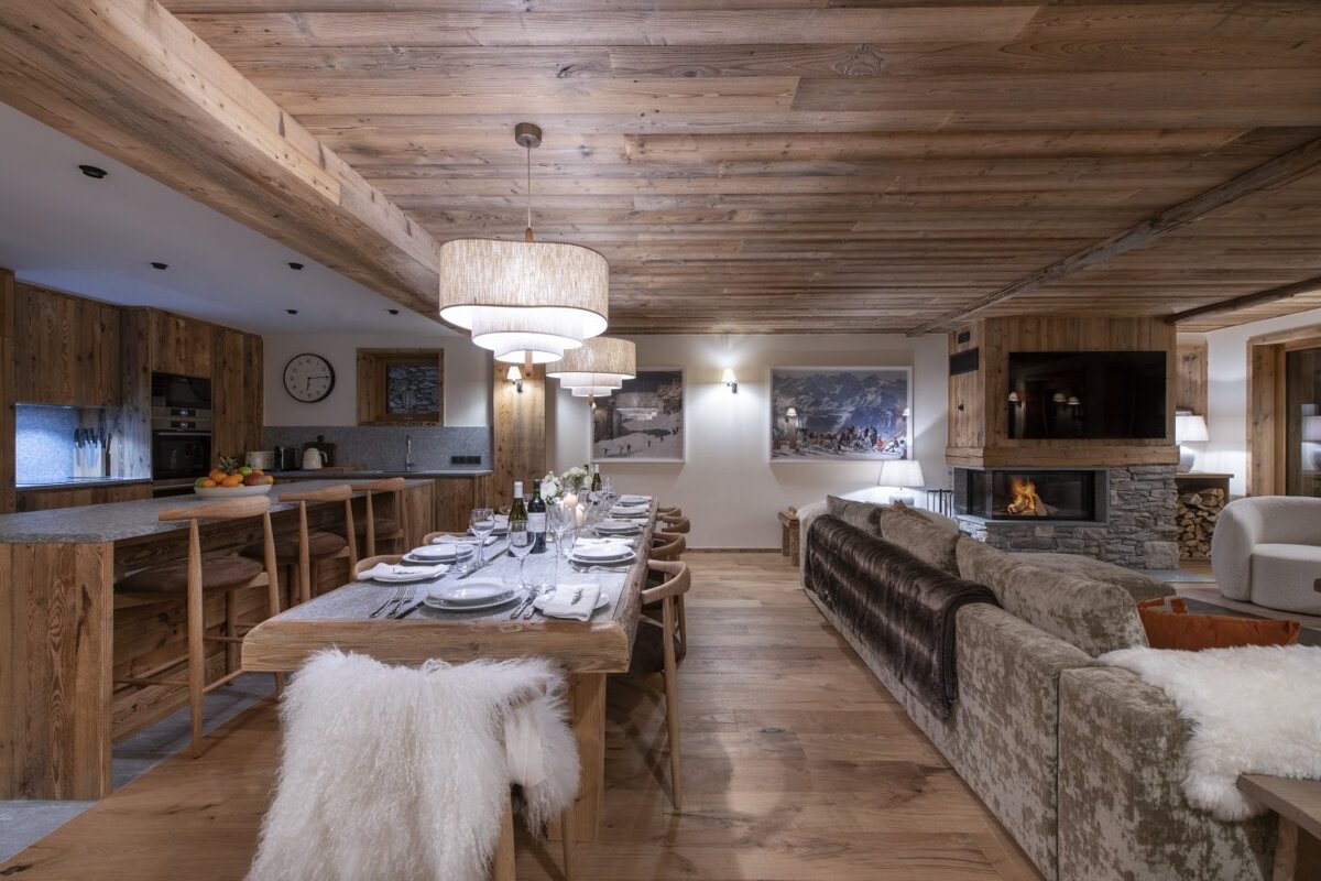 A dining room with a long table and a fireplace