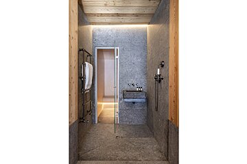 A bathroom with a sink and a walk in shower