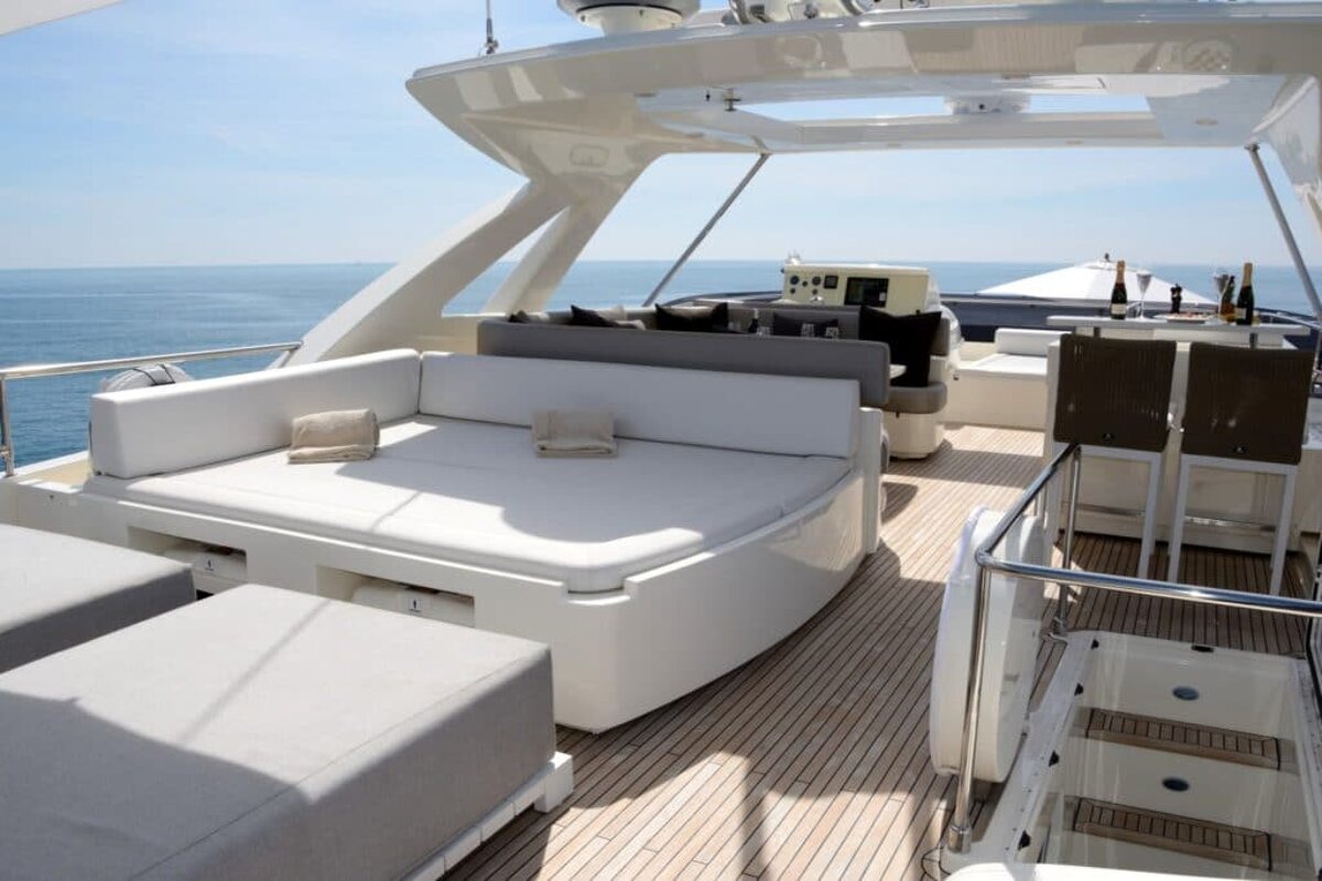 A boat with a couch and chairs on the deck