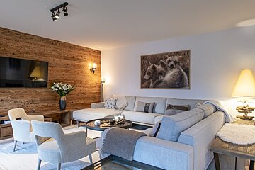 A living room with a couch and a picture of two bears on the wall