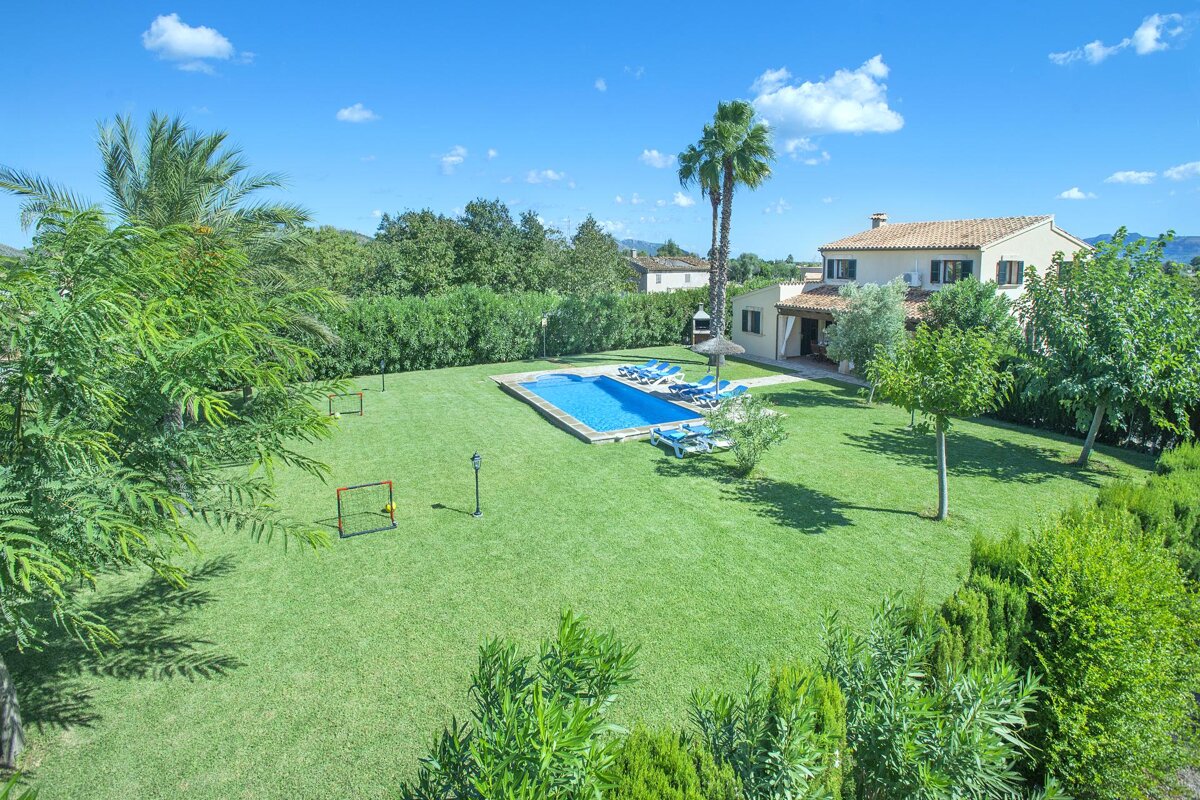 A large house with a large swimming pool in the backyard