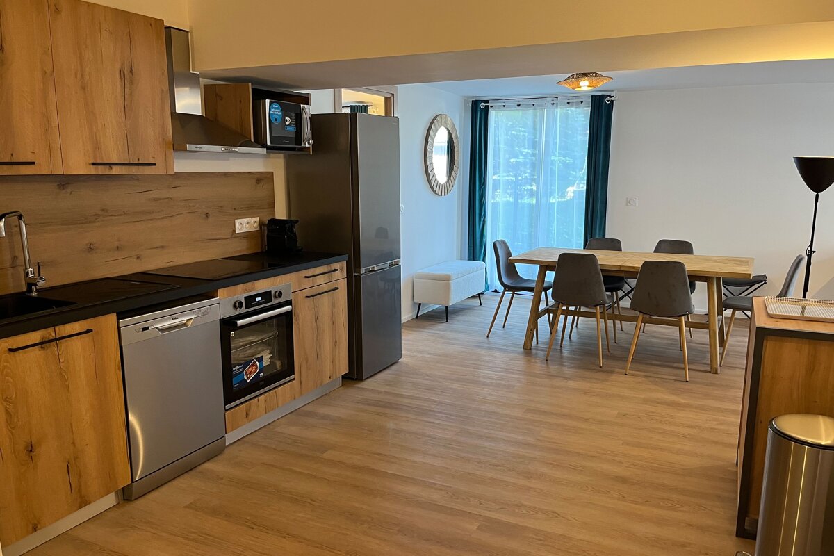 A kitchen with stainless steel appliances and wooden cabinets