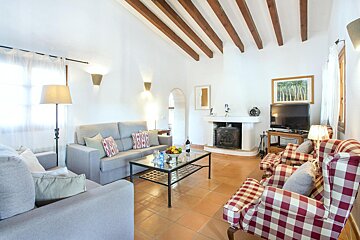 A living room with a couch and chairs and a fireplace