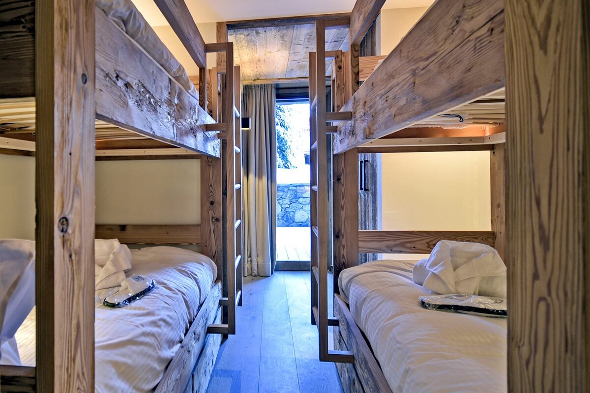 A room with bunk beds and a sliding glass door