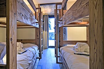A room with bunk beds and a sliding glass door
