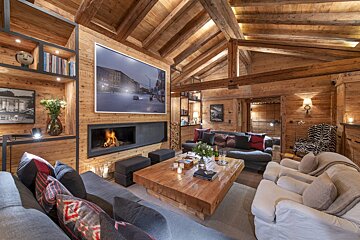 A living room with a fireplace couch and chairs
