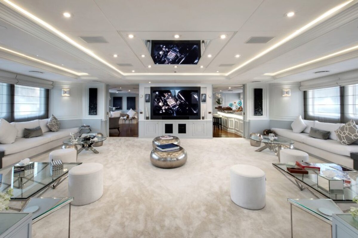 A living room with a flat screen tv on the ceiling