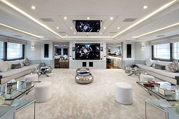 A living room with a flat screen tv on the ceiling