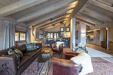 A living room with a couch and two chairs