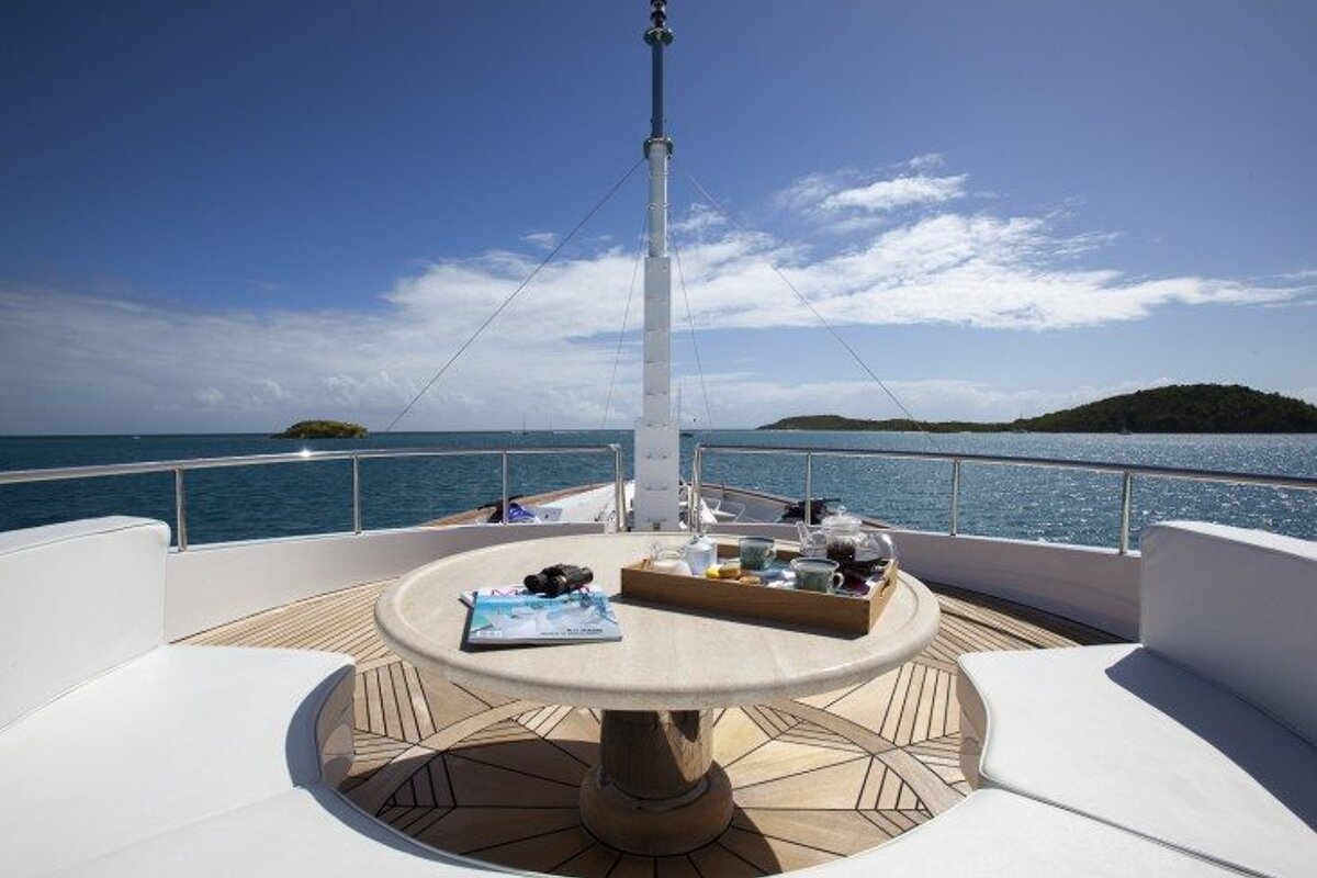 A table on the deck of a boat with a magazine on it