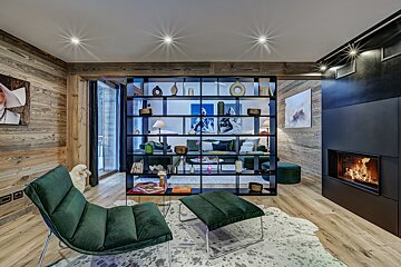 A living room with a green chair and ottoman