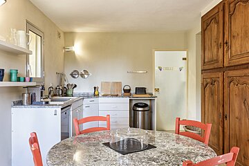 A kitchen with a sign on the wall that says hello