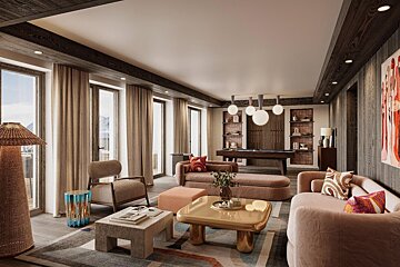 A living room with a pool table and a couch