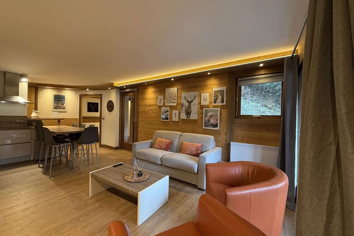 A living room with a couch and two chairs