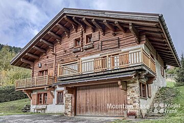 A large wooden house is for sale by mountain base
