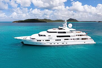 A large white yacht is floating in the ocean