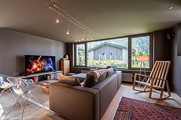 A living room with a couch and a rocking chair