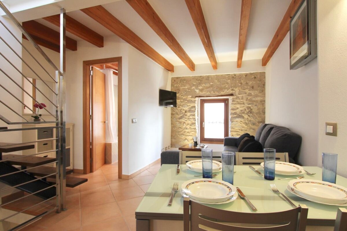 A living room with a dining table and a couch