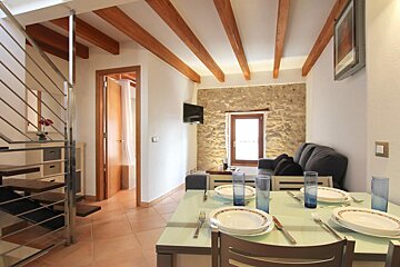 A living room with a dining table and a couch