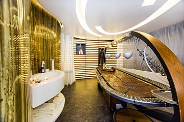 A bathroom with a wooden table and a bathtub