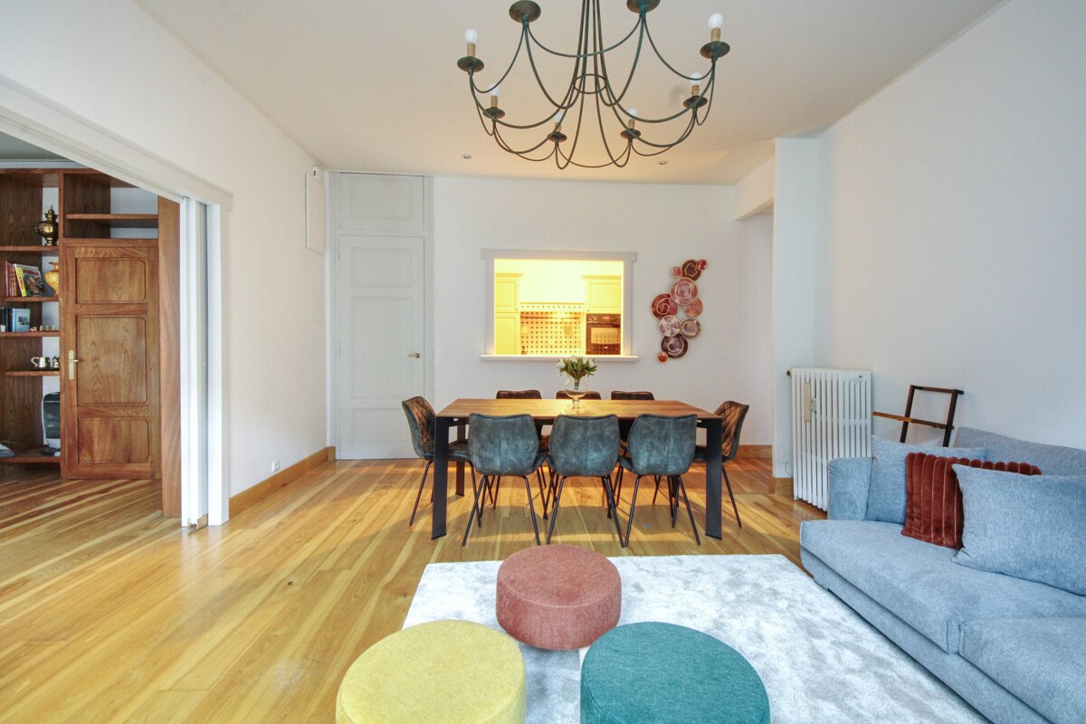 A living room with a table and chairs and a chandelier