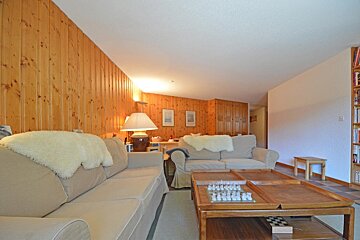A living room with a couch and two coffee tables