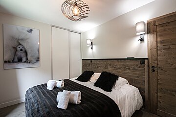 A bedroom with a picture of a polar bear on the wall