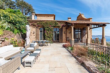 A large brick building with a patio in front of it
