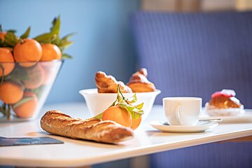 A table with a loaf of bread and a cup of coffee