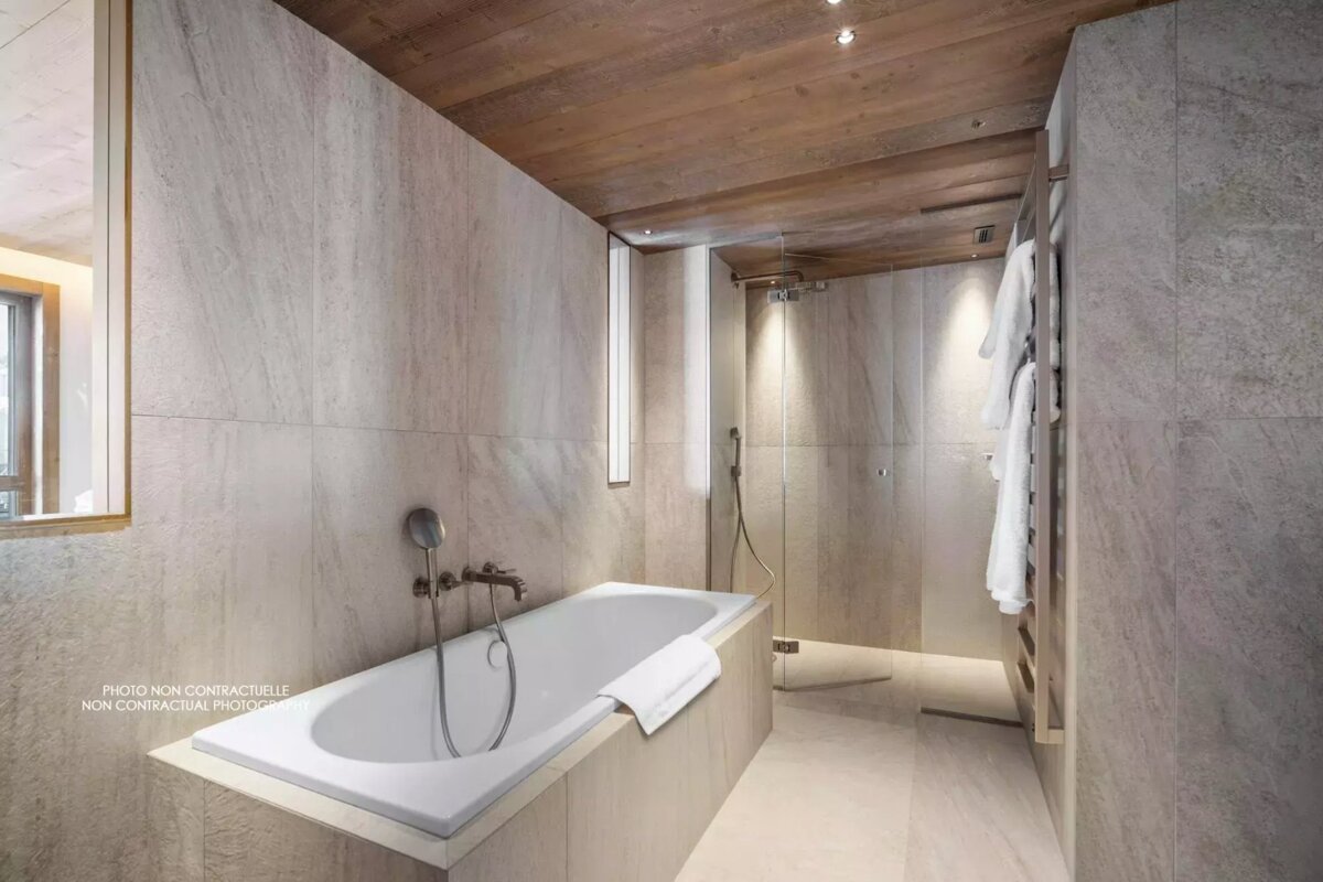 A bathroom with a bathtub and a walk in shower
