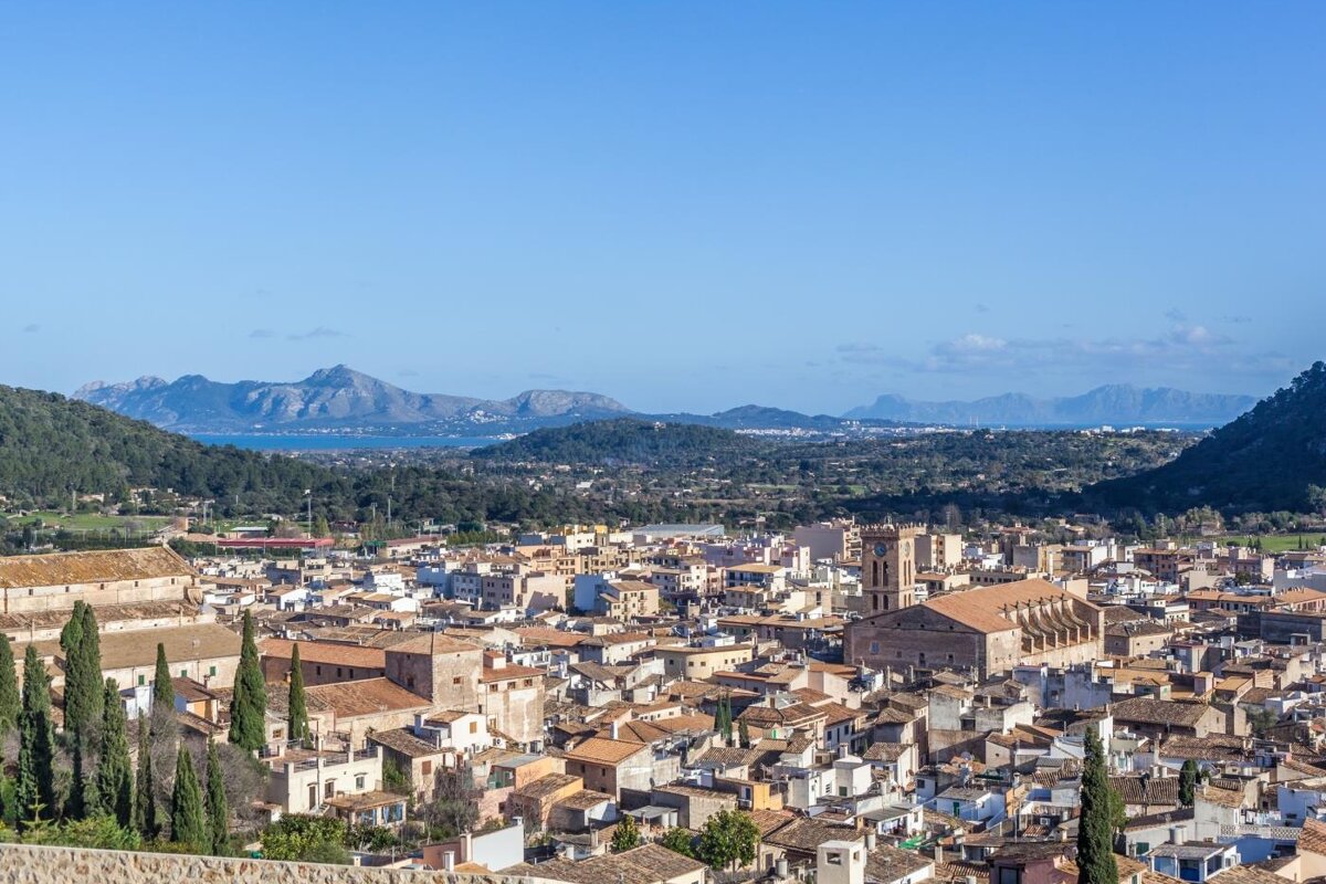 An aerial view of a city with mountains in the background