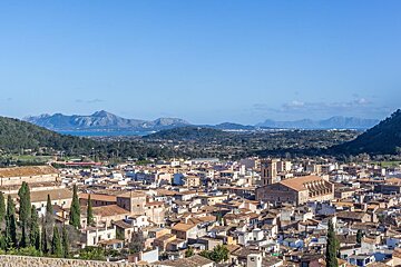 An aerial view of a city with mountains in the background