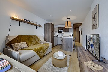A living room with a couch and a flat screen tv