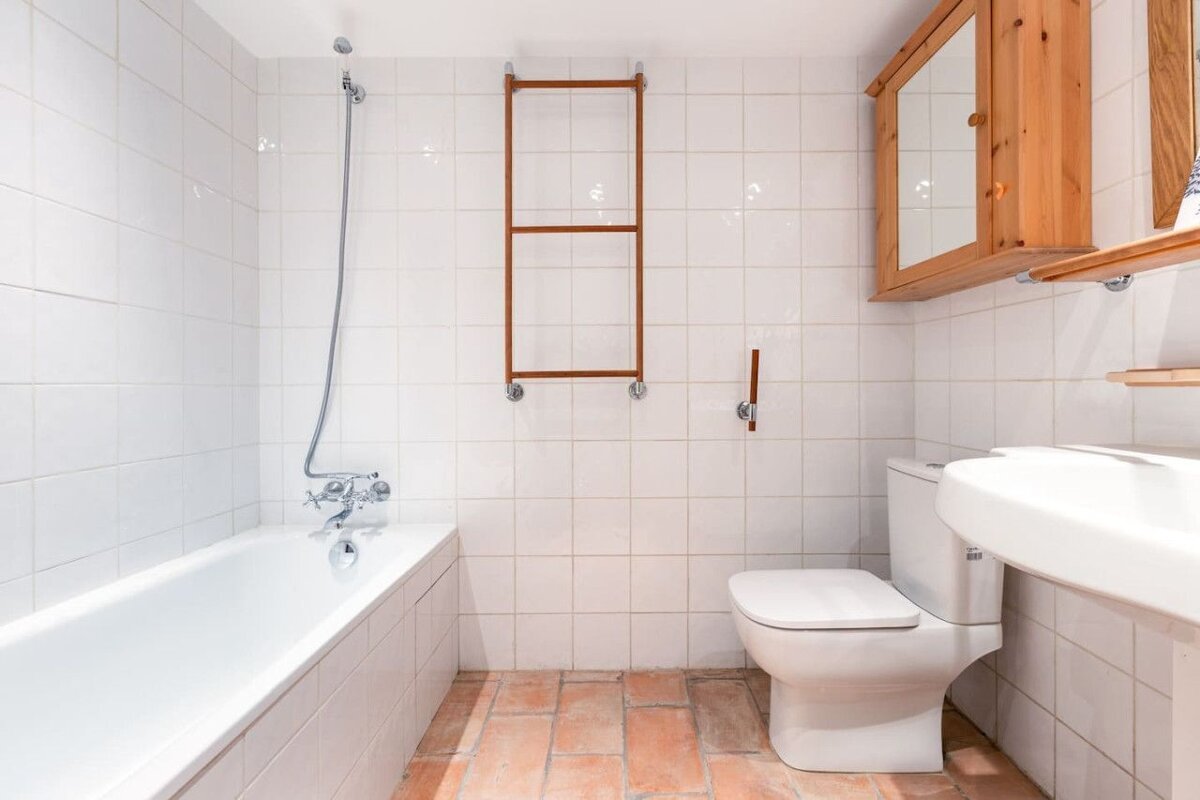 A bathroom with a bathtub toilet and sink