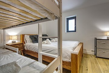 A bedroom with bunk beds and a window