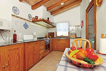 A kitchen with a basket of fruit on the table