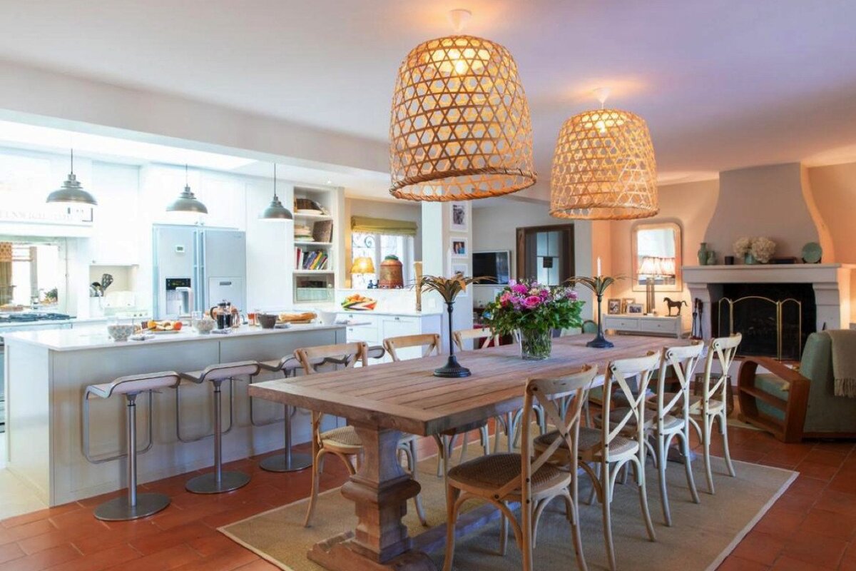 A dining room with a long wooden table and chairs