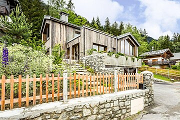 A house with a wooden fence in front of it