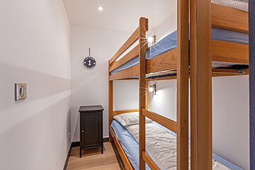 A bunk bed with the number 1 on the wall above it