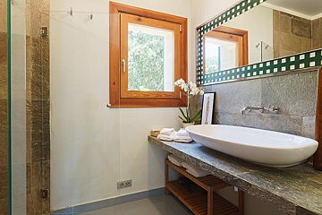 A bathroom with a sink a mirror and a window