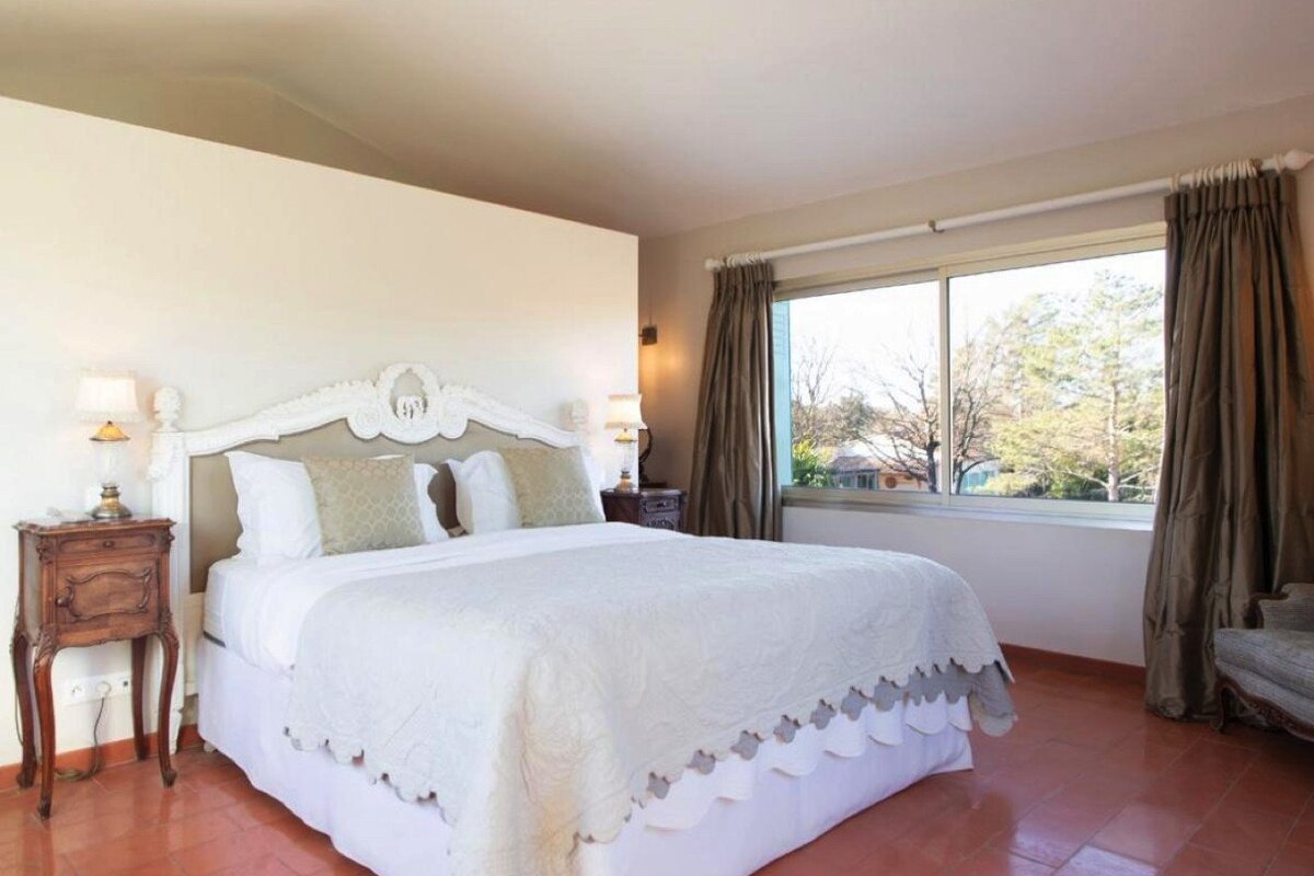 A bedroom with a large bed and a window