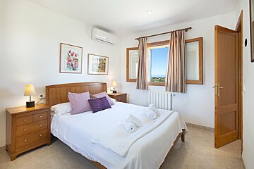 A bedroom with a large bed and two nightstands