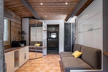 A living room with a couch and a mirror