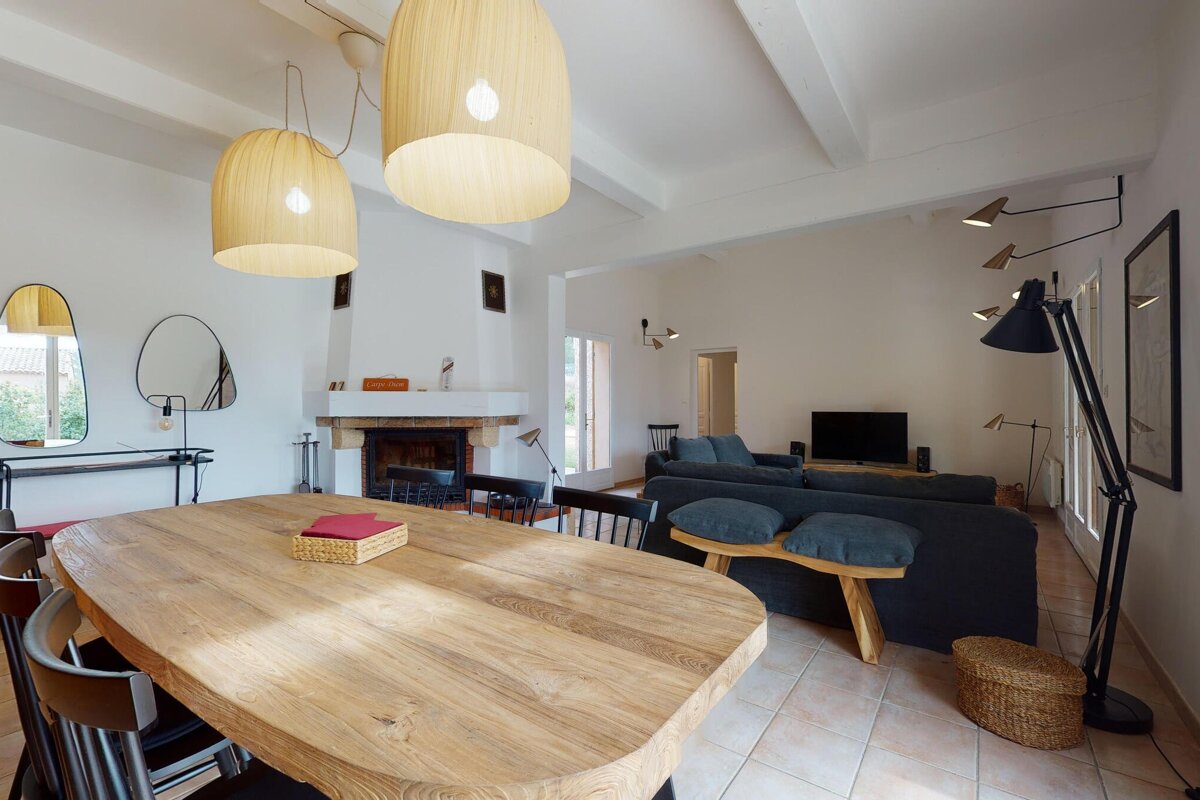 A living room with a wooden table and chairs