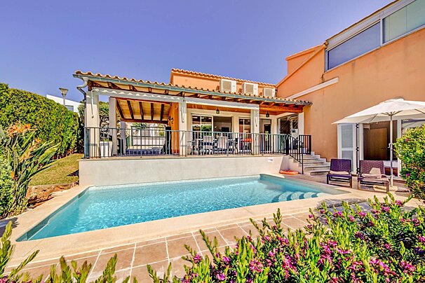 A large house with a swimming pool in front of it