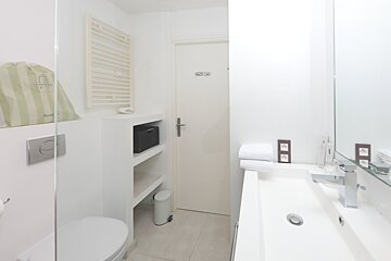 A bathroom with a toilet and a sink and a sign that says ' toilette ' on it