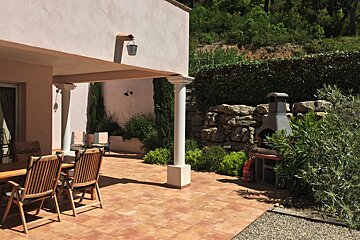 A patio with a table and chairs and a heineken chair