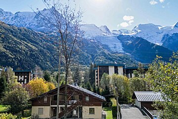 A house in the mountains with a sign that says hi