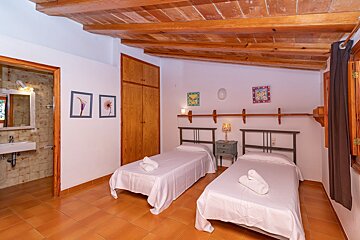 A bedroom with two twin beds and a sink