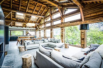 A living room with a lot of windows and a skylight